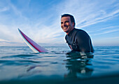 'A Man In The Water With His Surfboard At Bunker Beach; Tarifa, Cadiz, Andalusia, Spain'