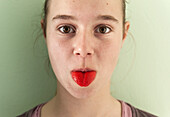 Portrait Of Girl Sticking Out Her Bright Red Tongue