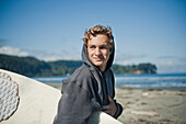 'A Young Man Carries His Surfboard On The Beach At Twin Rivers; Washington United States Of America'