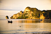 'A Boat In The Water At Sunset; Phi Phi Islands, Thailand'