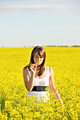 Young Woman In A Canola Field