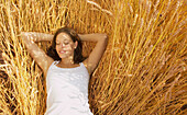 Woman Lying In A Field Of Wheat