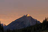 'Sunrise Lights Up A Mountain Peak; Alberta, Canada'