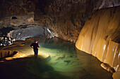 'A Filipino Tour Guide Holds A Lantern Inside Sumaging Cave Or Big Cave Near Sagada; Luzon Philippines'