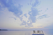 'Two Folding Lawn Chairs On Dock At Clear Lake; Canada, Manitoba, Riding Mountain National Park'
