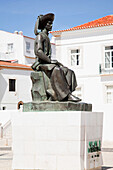 'Statue Of A Man Seated On A Stone; Lagos Algarve, Portugal'