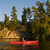 'A Girl In A Red Kayak; Lake Of The Woods, Ontario, Canada'