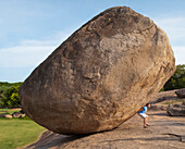 'A Man Stands Under A Large Boulder At Arjuna's Penance; Mahabalipuram, Tamil Nadu, India'
