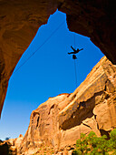 'A female athlete rappeling down a dry utah slot canyon waterfall;Hanksville utah united states of america'