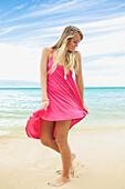 'A teenage girl with long blond hair poses on the beach;Maui hawaii united states of america'