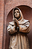 'Close up of a monk statue inside brick arch;Bologna emilia-romagna italy'