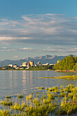 'The anchorage city skyline seen from the tony knowles coastal trail during high tide, chugach mountains in the background;Anchorage, alaska, united states of america'