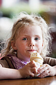 Young Girl Eating A Ice Cream Cone While Sitting In A Coffe Shop On A Rainy Day In Seward, Summer, Seward, Southcentral Alaska, Usa
