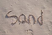 'The word sand handwritten in the sand; Tulum, Mexico'