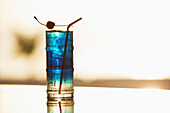 'Blue cocktail with cherry and a straw; Caribbean'