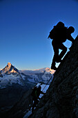 Sunrise at the Matterhorn: mountaineers on the Arbengrat of Obergabelhorn (4034 m), Wallis, Switzerland