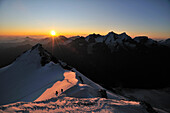Sunrise on the Bishorn: mountaineers in front of the Mischabel-Group, Wallis, Switzerland