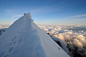 Mountaineers crossing the Aiguille de Bionnassay, Mont Blanc, France