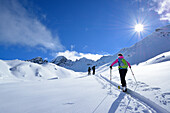 Drei Personen auf Skitour steigen zum Piz Laschadurella auf, Sesvennagruppe, Engadin, Graubünden, Schweiz