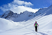 Female back-country skier ascending to Piz Laschadurella, Sesvenna Alps, Engadin, Graubuenden, Switzerland