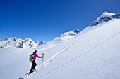 Female back-country skier ascending to Eiskoegele, Obergurgl, Oetztal range, Tyrol, Austria