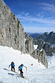 Two back-country skiers ascending towards Griesner Kar, Wilder Kaiser, Kaiser Mountains, Tyrol, Austria