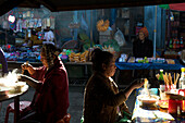 Women eating noodle soup at the market in Kyaing Tong, Kentung, Shan State, Myanmar, Burma