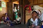 Longneck Karen women wearing typical necklaces, a thirteen year old school girl getting a necklace for the first time, Padaung women near Loikaw, Kayah State, Karenni State, Myanmar, Burma, Asia