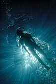 Underwater view of a woman snorkeling in blue water, Praia, Santiago, Cape Verde