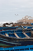 Fishing boats in the harbour of Essaouira with view of the city, Essaouira, Morocco