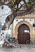 Cycles in front of a typical moroccan door, Essaouira, Morocco