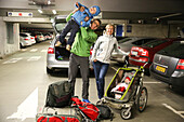 Young family with children, departure at airport, car parking area, baby, small boy, luggage, stroller, backpack, parental leave, trip to asia, travel, MR, Leipzig, Saxony, Germany
