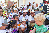 Balinese children playing with foreign boy, kids, making fun, making faces, temple ceremony, traditional dress, clothes, boy 3 years old, blond, intercultural contact, meeting local people, locals, family travel in Asia, parental leave, German, European, 