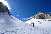 Female back-country skier ascending in Val Culea, Sella, Sella Group, Dolomites, South Tyrol, Italy