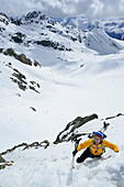 Female back-country skier ascending to Porta d Es-cha, Piz Kesch, Engadin, Canton of Graubuenden, Switzerland
