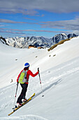 Female back-country skier ascending to hut Eisbruggjochhuette, Hoher Weisszint, Zillertal Alps, South Tyrol, Italy