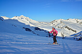 Female back-country skier ascending to Grossvenediger, Venediger Group, High Tauern National Park, Salzburg, Austria