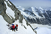 Back-country skiers resting at Glocknerleitl, Pasterze glacier in background, Grossglockner, Glockner Group, Hohe Tauern National Park, East Tyrol, Tyrol, Austria