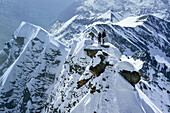 Three persons standing on summit of Kleinglockner, Grossglockner, Glockner Group, Hohe Tauern National Park, East Tyrol, Tyrol, Austria