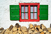 Wood pile below an alpine hut window, Spitzstein, Chiemgau Alps, Tyrol, Austria