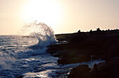 Wave crashing onto rocky coastline at sunset, near Santanyi, Mallorca, Balearic Islands, Spain, Europe