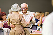 An elderly couple dancing happily together at the afternoon dance in the Wandelhalle Bad Wildungen, Bad Wildungen, Hesse, Germany, Europe