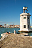 Small lighthouse at the entrance to the marina on Isola di San Giorgo Maggiore island along Bacino di San Marco, Venice, Veneto, Italy, Europe