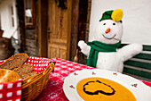 Snowman eating pumpkin cream soup, Styria, Austria