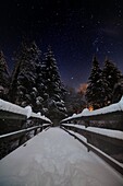 Snowy bridge after the heavy snowfall of winter 2012/2013, at the lake Fiorenzo, in Montepiano, Apennines Tuscany.