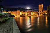 Moonrise over Scaligero bridge in Verona, in first floor Adige River.
