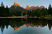 Welsperg lake under the summits called Pale di San Martino, inside the sunrise's lights, Dolomites