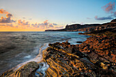 A view of the cliffs of San Vito lo Capo, on the sea at sunset