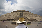A man wearing a straw hat stands facing the Pyramid of the Sun, or Pyramide del Sol, in the Pre-Columbian archeological site of Teotihuacan, Mexico state, Mexico, on June 23, 2008. The pyramid measures 738 ft 225 m, across and 246 ft 75 m, high, making it