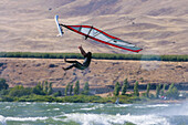 Windsurfer in suspended animation mid back loop - Arlington, OR.